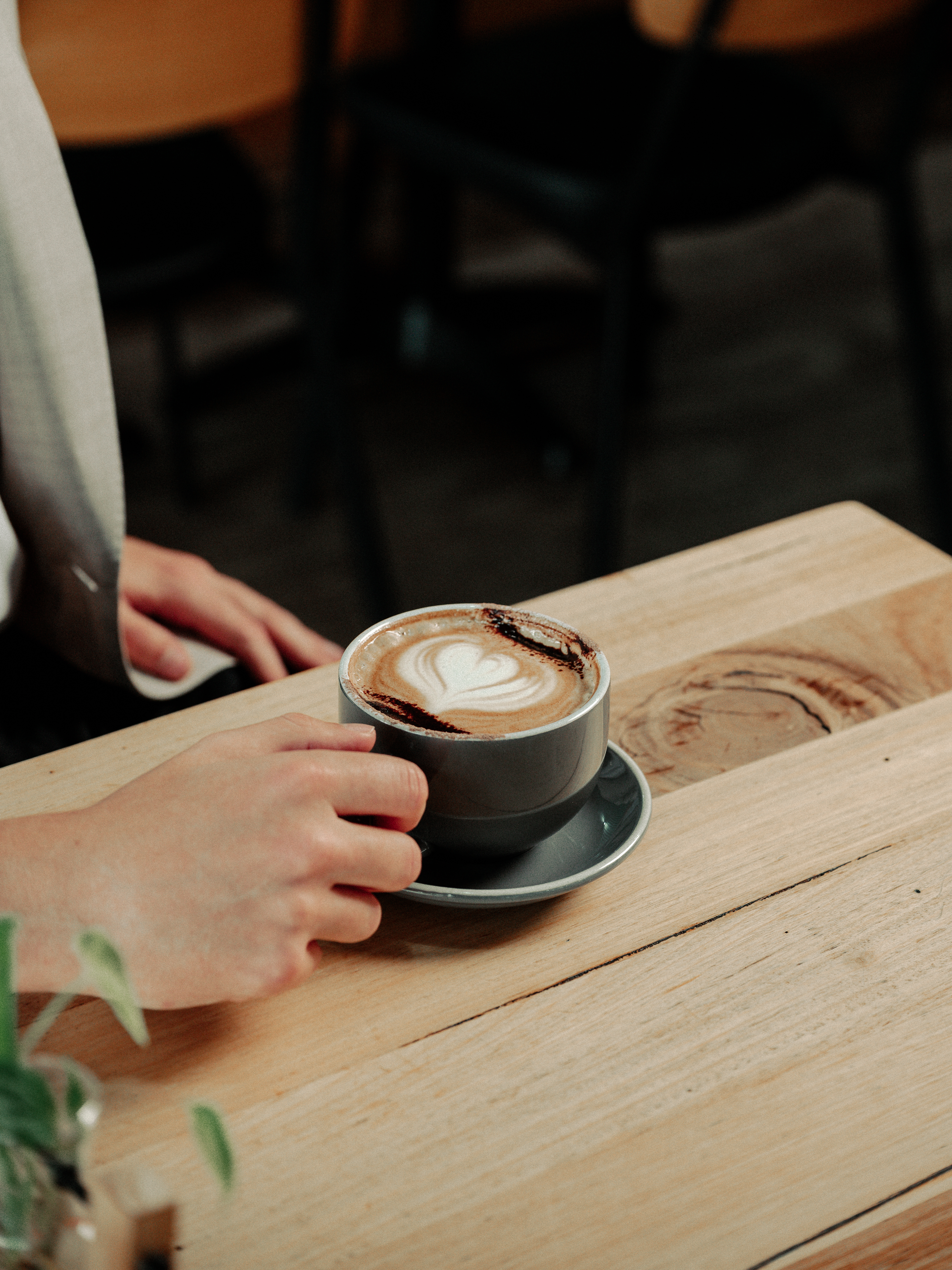 Coffee with latte art being served at a café